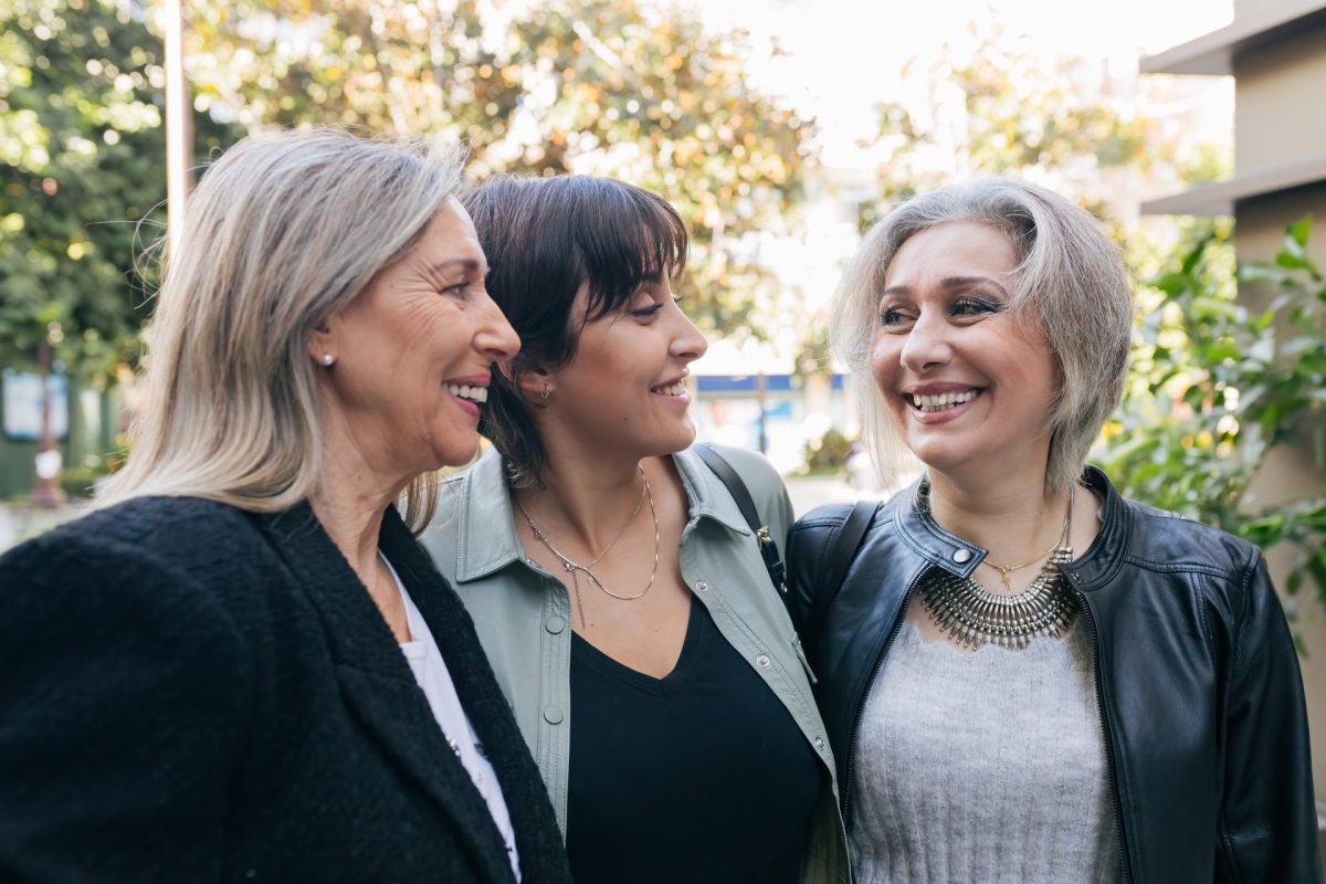 Stylish adult women standing together on sidewalk 2025 01 09 02 47 06 utc